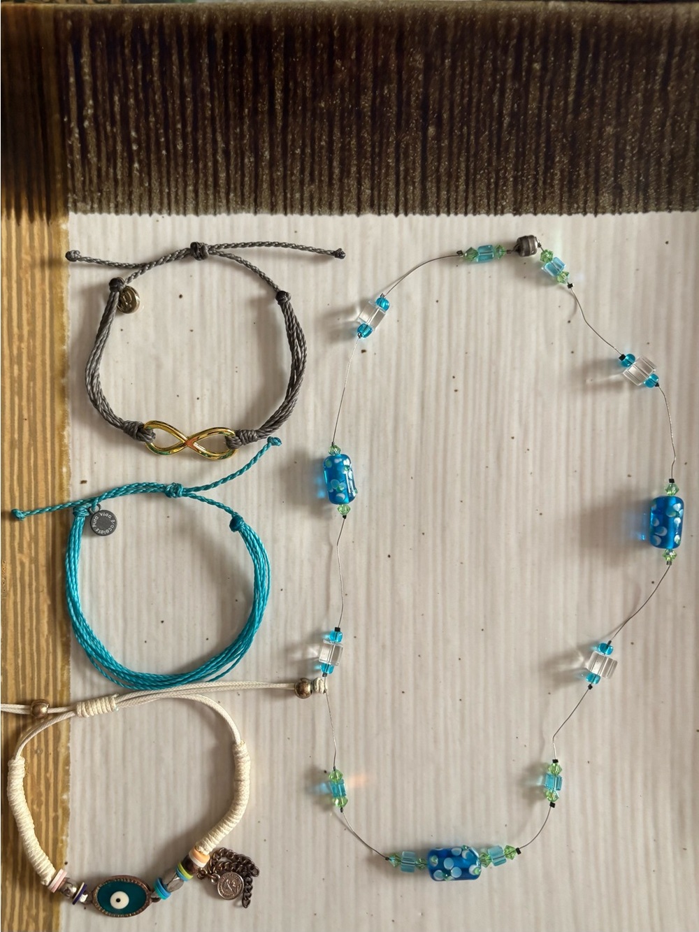 3 cord bracelets. 1 beaded Necklace. Pura Vida and evil eye bracelet. $18.00